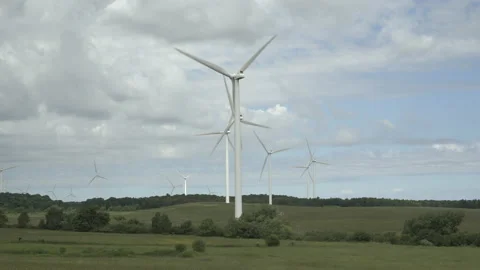 Wind Farm and Clouds from a Grassy Field Stockbeeldmateriaal 197569339