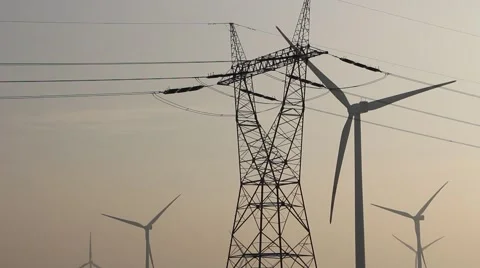 Wind farm and power lines at dusk closeup Stock Footage