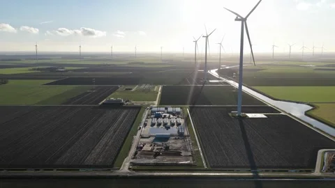Wind farm developing renewable energy infrastructure on agricultural land 動画素材 346958711