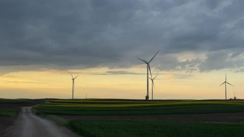 Wind Farm at Dusk Across Rolling Agricultural Landscape Stock Footage 335809172