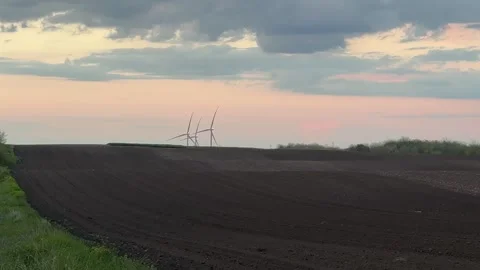 Wind Farm at Dusk Across Rolling Agricultural Landscape Stock Footage 335809631