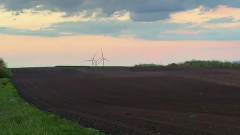 Wind Farm at Dusk Across Rolling Agricultural Landscape Stock Footage 335809886