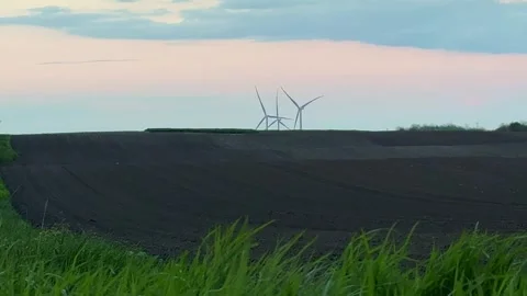 Wind Farm at Dusk Across Rolling Agricultural Landscape Stock Footage 335809918
