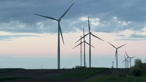 Wind Farm at Dusk Across Rolling Agricultural Landscape Stock Footage 335809939