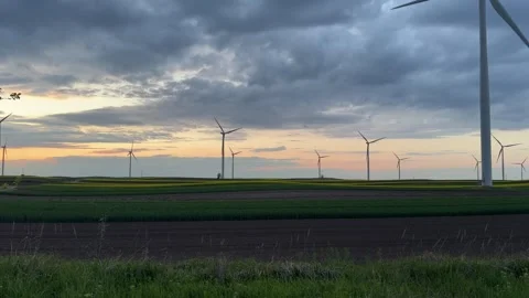 Wind Farm at Dusk Across Rolling Agricultural Landscape Stock Footage 335810599