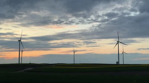 Wind Farm at Dusk Across Rolling Agricultural Landscape Stock Footage 335810616