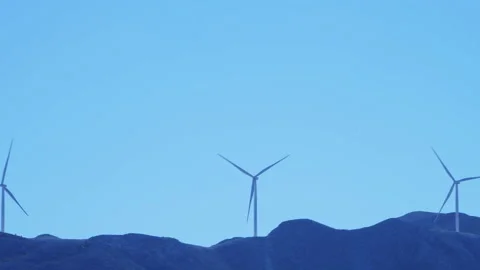 A wind farm on a far mountain. Stock Footage 220063924