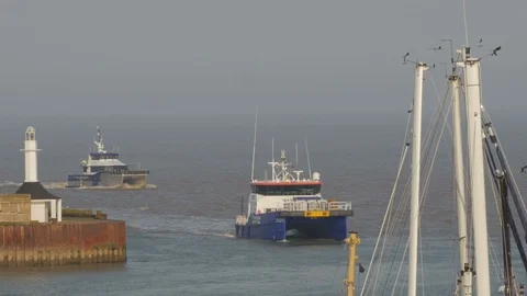 Wind Farm Fast Support Vessels returning to harbour, Lowestoft, Suffolk, England Stock Footage 88841281