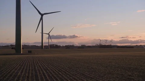 Wind farm in a field at sunset Video stock 86391046