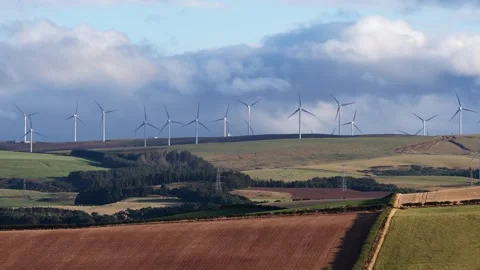 Wind farm generating renewable energy on rolling green hills Stock Footage 346533467