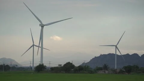 Wind farm with large blades rotating on windmills on meadow Stock Footage 157321139
