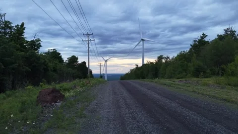 Wind farm low down road 6-21-26 Stock Footage 341401438