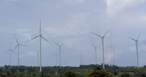 Wind farm with multiple turbines producing renewable electricity under calm sky, Stock Footage 321043431