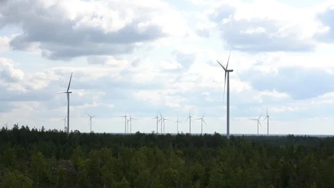 Wind farm, multiple wind turbines over pine forest in Finland Stock-Footage 117357269