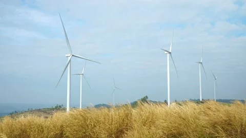 Wind farm for power generation in beautiful skies and swaying grass Stock-Footage 168361545