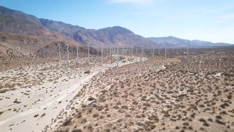 Wind Farm Rows Beneath Desert Mountains, 4K Stock Footage 197018034