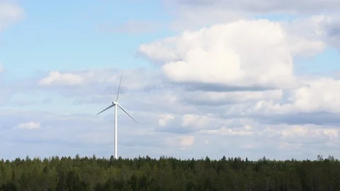 Wind farm, single wind turbine, standing tall over pine forest in Finland 動画素材 117352900