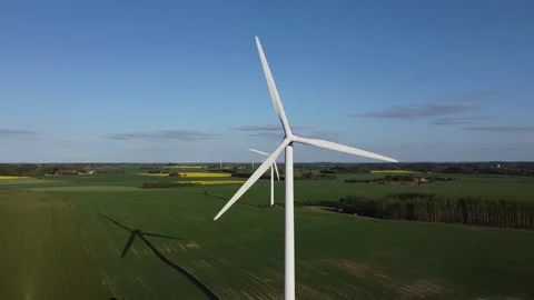 A wind farm stands in a field, generates electricity, summer clear weather Stock Footage 196001800