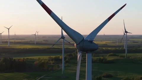 Wind farm at sunrise, wind generators aerial view, windmills generating Video stock 308481539