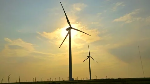 Wind Farm at Sunset on a Cloudy Sky Background Stock Footage 142389014