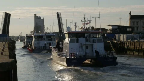 Wind Farm Support Vessels underway, returning home through the opened bridge Stock Footage 80270983