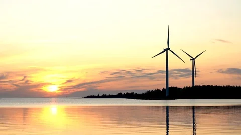 Wind farm, Time-lapse of two wind turbines at sunset with beautiful yellow sky Stock-Footage 117349915