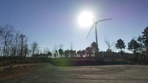 Wind farm with turbines spinning in front of Sun, with big shadows moving 4k UHD Stock Footage 45441365