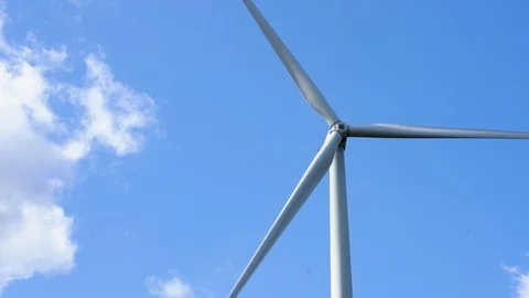 Wind farm, wind turbine producing green energy by spinning in the wind Video stock 117354595