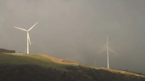 Wind farm with wind turbines making green energy covered with foggy clouds Video stock 42666582