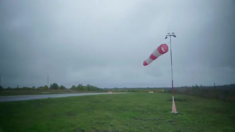 A wind flag in cloudy weather on the runway. Stock Footage 219329582