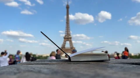 Wind Flipping Notebook Pages Eiffel tower on background Stock Footage 243731757