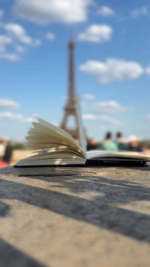 Wind Flipping Notebook Pages Eiffel tower on background Stock Footage 249317056