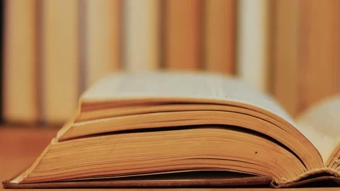 Wind flips yellowed pages of an old book Stock Footage 237497635