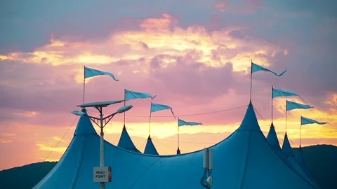 In the wind fluttering flags on the circus tent against the beautiful evening Stock Footage 92165057