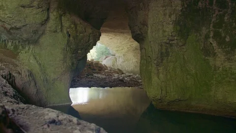 Wind generating ripples on the surface of a lake in a cave Stock Footage 89604030