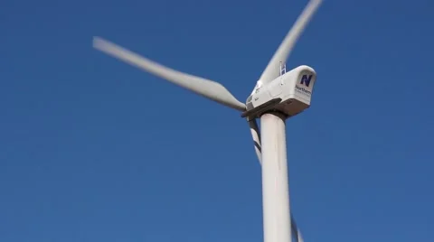 A wind generator against a blue sky Stock Footage 43041993
