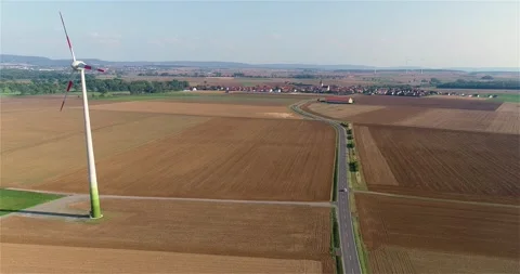 Wind generator on the background of the city. Wind turbine in the field. Wind Stock Footage 265070047