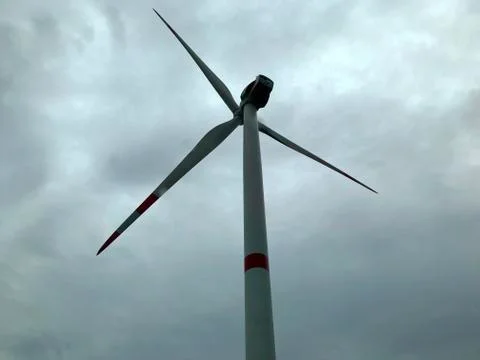 Wind generator on a background of cloudy sky. Stock Photos