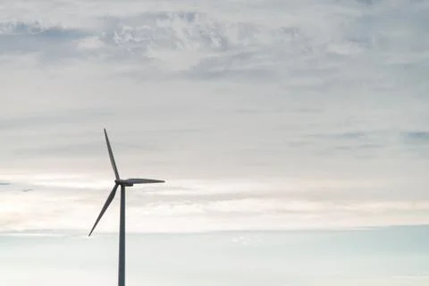 Wind generator on blue sky background Foto stock