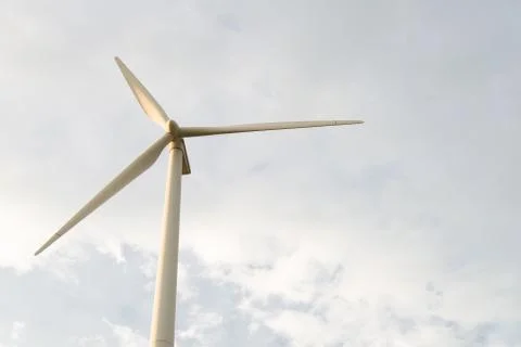 Wind generator on blue sky background Stock Photos