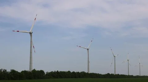 Wind generator in cloudy sky Stock Photos