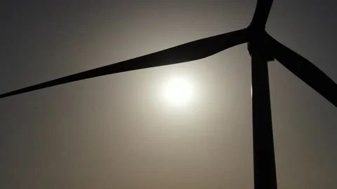 Wind generator, large blades at sunset. Sunlight through the sweeping blades Stock Footage 132202281