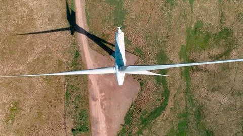 Wind generator in the process of generating electrical energy in a wind farm Stock Photos