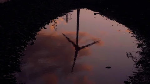 Wind generator reflection on puddle. Stock Footage 97464854
