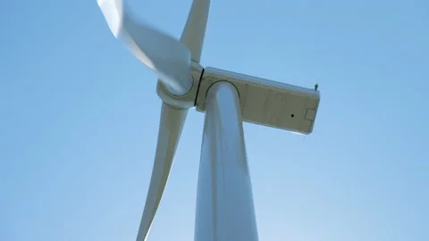 Wind generator with rotating blades against clear sky Stock Footage 158164104