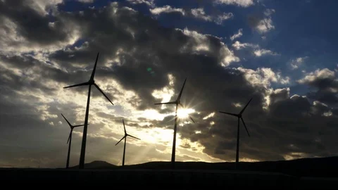 Wind generator silhouettes with godrays sunset behind. Stock Footage 97463606
