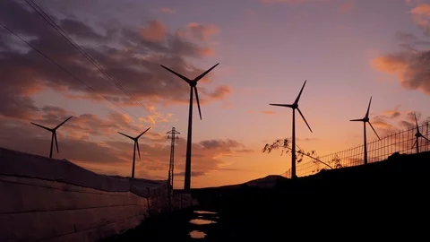 Wind generator silhouettes with orange clouds at sunset. Stock Footage 97464874