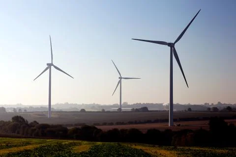 Wind generators among green fields Stock Photos