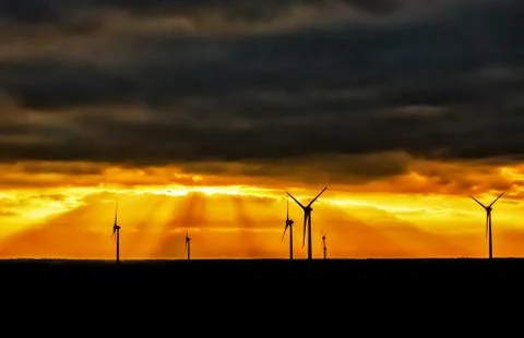 Wind generators on the background of beautiful sunset Stock Photos