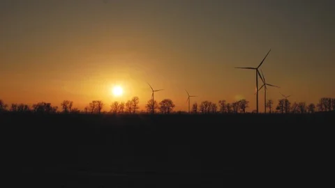 Wind generators on the background of trees at sunset.wind power plants Stock Footage 103141445